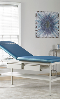 Treatment table with adjustable back and two drawers.